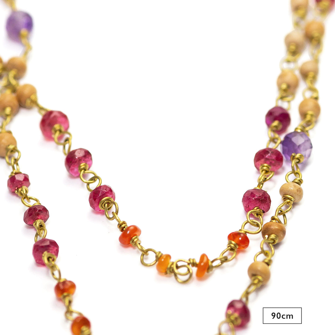 Detail of the 90cm gemstone necklace "Prana" made of high-quality gold-plated sterling silver with rubies, carnelians, amethysts, and sandalwood by Eternal Bliss
