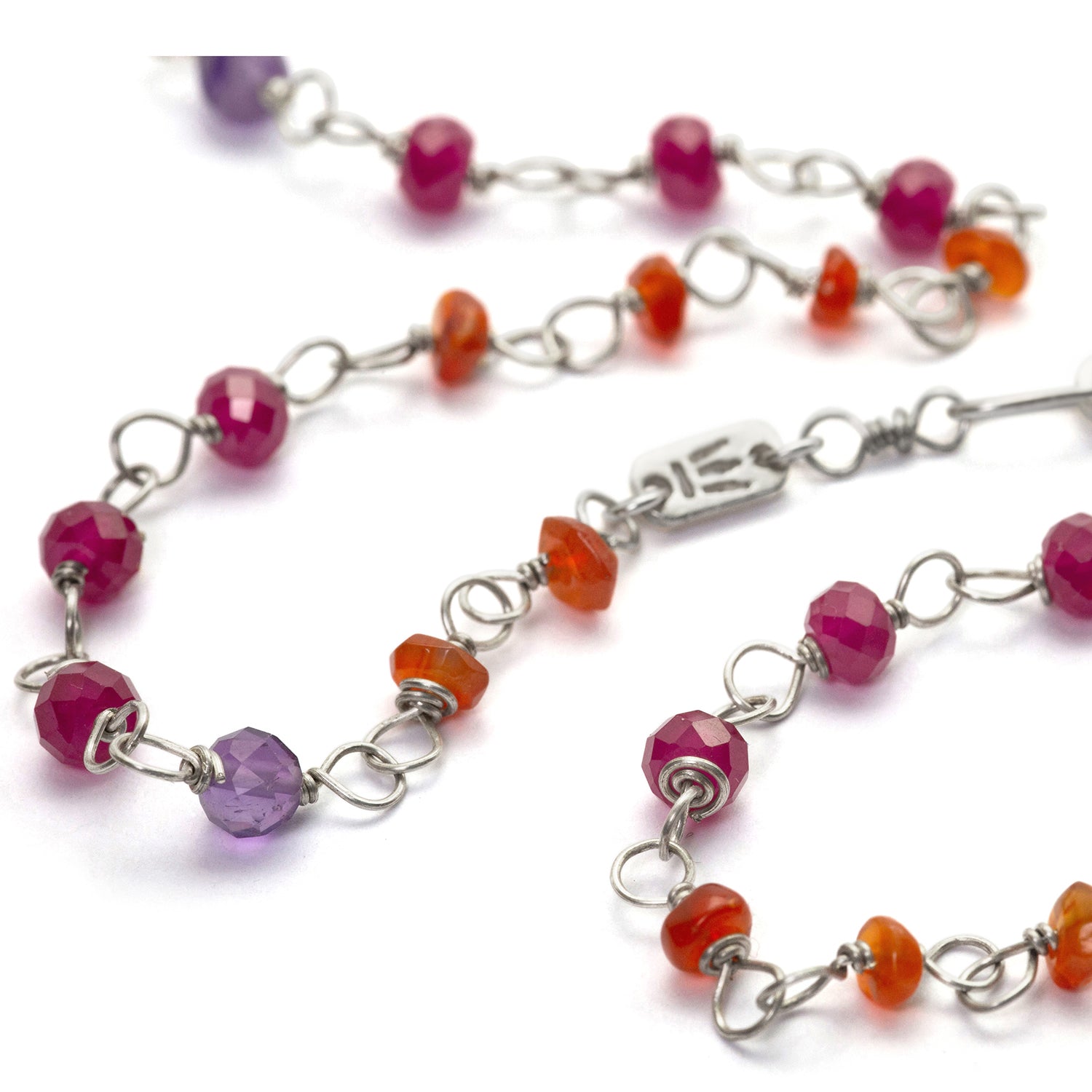 Detail of the gemstone necklace "Prana" made of high-quality sterling silver with rubies, carnelians, amethyst and sandalwood by Eternal Bliss