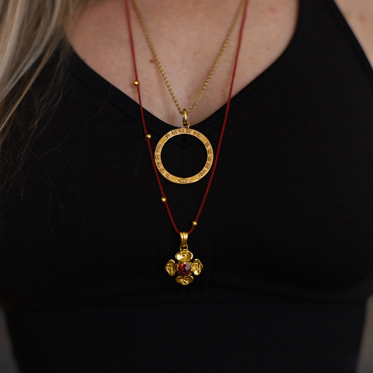 Closeup von Hedys Wurzel Chakra Kette mit einem Granat Edelstein aus hochwertig vergoldetem Sterling Silber von ETERNAL BLISS