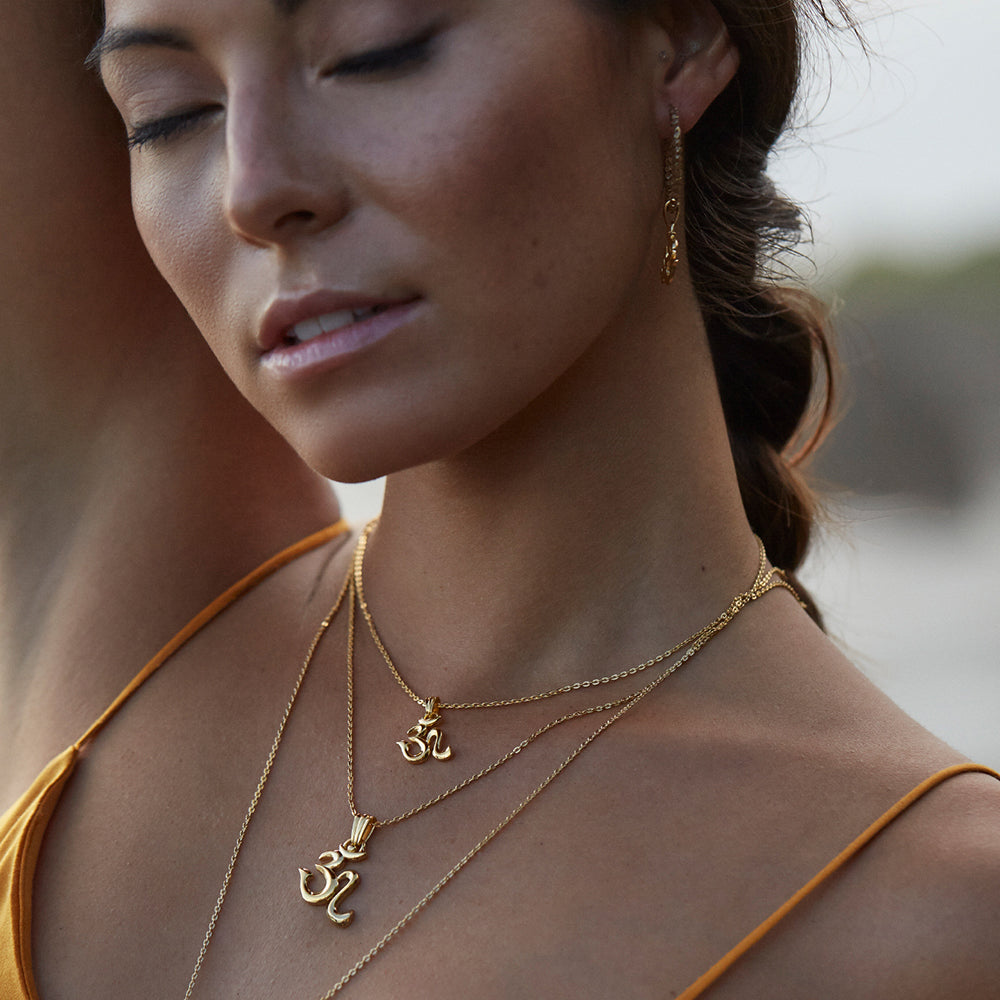 Gold-plated Om necklace mini is worn by yoga teacher and model Steffi