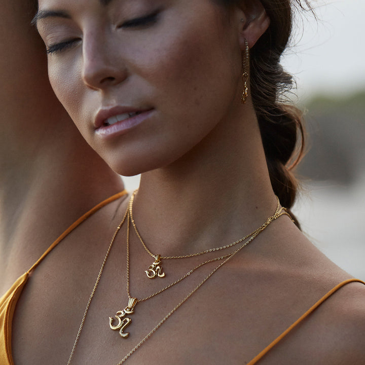 Gold-plated Om necklace mini is worn by yoga teacher and model Steffi